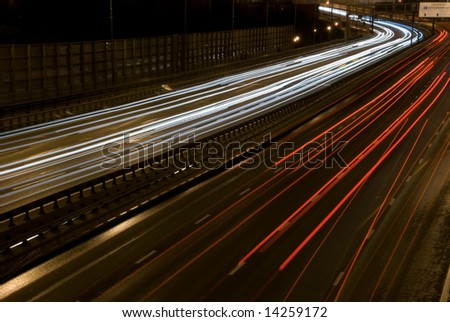 A long time exposure of a urban night traffic lights. Road perspective