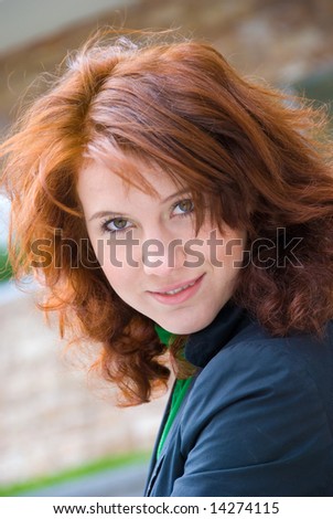 Cute young smiling redhead woman closeup portrait
