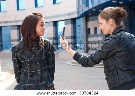 Girl take a picture of an other girl on a street