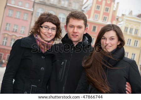 Three friends on a street in old city
