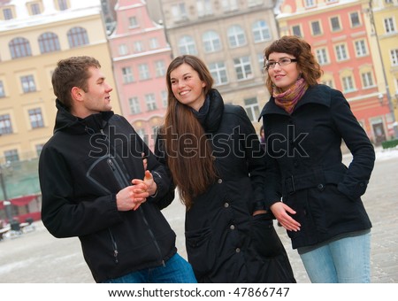 Three friends on a street in old city
