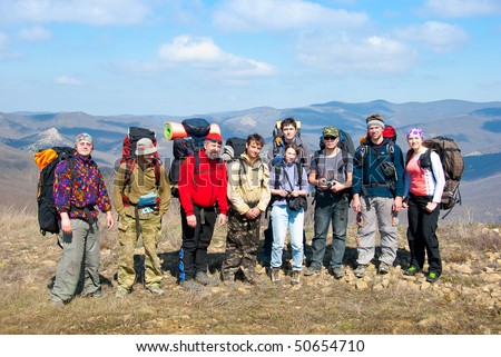 Hikers group on a peak in mountains