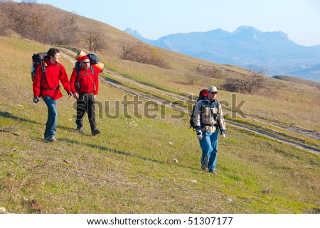Hikers group walking in spring mountains
