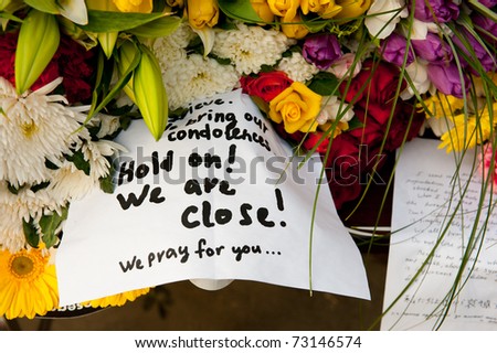 MOSCOW - MARCH 14: Flowers and a note of sorrow as a sign of sympathy to Japanese people affected by earthquake at the Japanese Embassy on March 14, 2011 in Moscow, Russia.