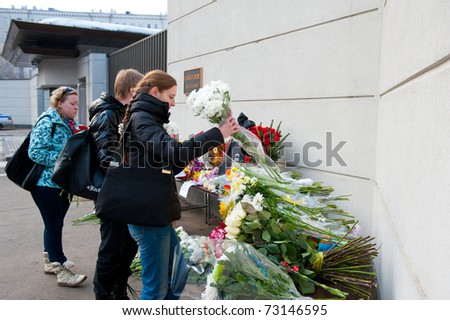 MOSCOW - MARCH 14: Unidentified people bring flowers to the Japanese embassy as a sign of sorrow and sympathy to the Japanese people affected by earthquake on March 14, 2011 in Moscow, Russia.