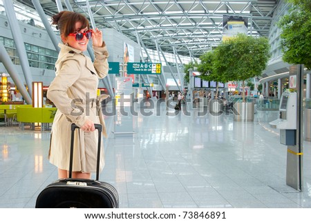 Young woman with luggage at the international airport