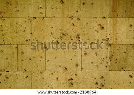 Background Texture sand stone with bulletholes