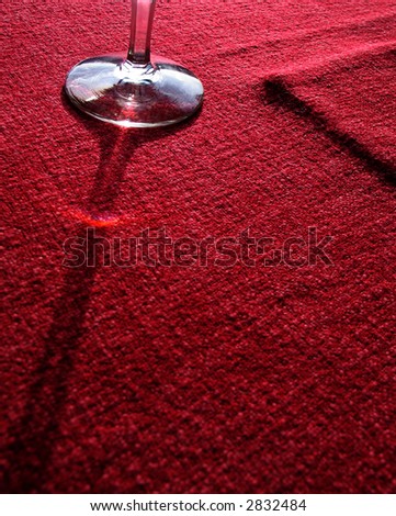 glass casting shadow on red table-cloth