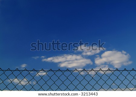 mesh wire fence against blue sky