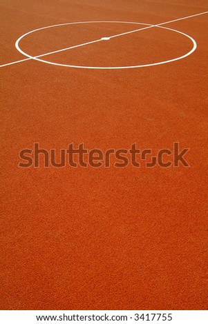basketball court with a red rubber floor