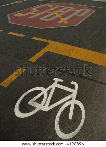 bicycle sign and stop sign on the road