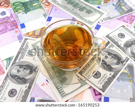 tea or coffee cup on money wallpaper