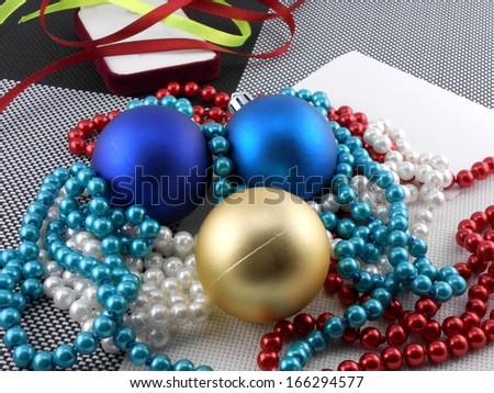 christmas ball and pearls on a plate, new year holiday card