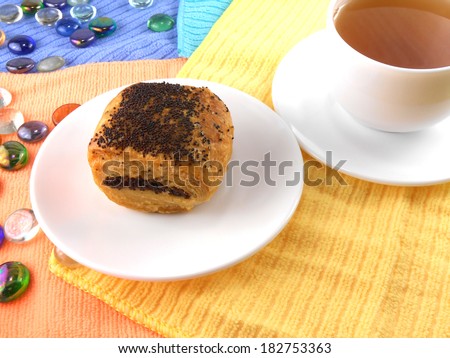 polish poppy seed cake on white plate and cup of tea (coffee) and stone set