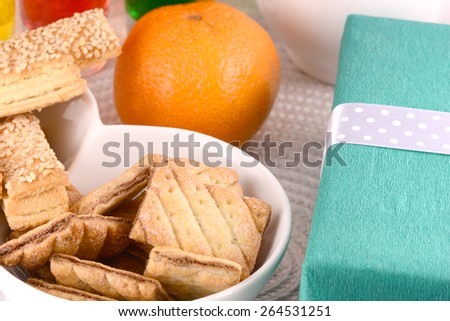 sweet cake on white plate, gift box, fruits and juice