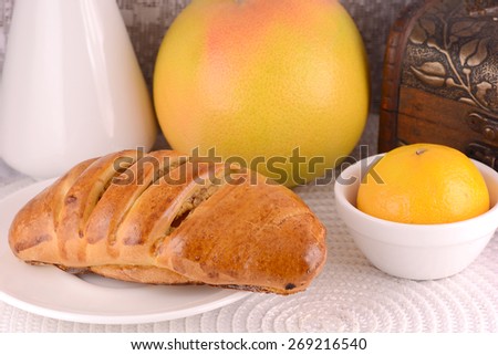 sweet cake on white plate and fruits, orange, lemon, mandarin, health food concept