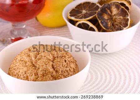 sweet cake on white plate, old fruits, lemon, cinnamon and red wine