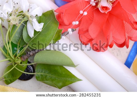 Office table with flower, ribbons, pencil, candles