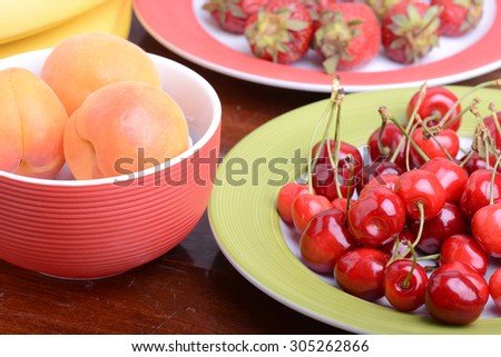 Fresh berries background: apricots, cherries, strawberry