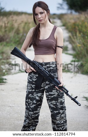 A beautiful military woman with an automatic rifle ak-74