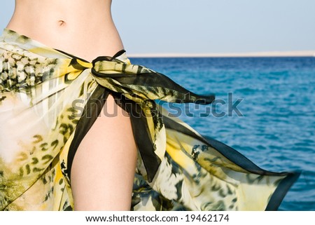Woman tummy in beach shawl