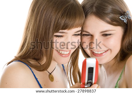 stock photo Two pretty girls reading SMS on mobile phone isolated on white 