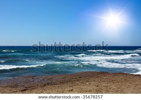 Blue sky, beach, sun and sea with waves