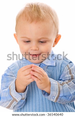 Portrait of little boy holding something. Isolated on white background