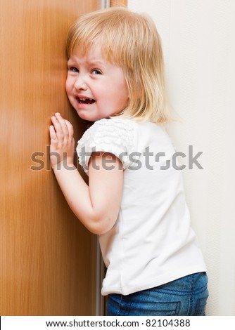 stock photo Naughty little girl is standing in the corner