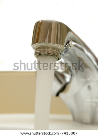Close-up of head of mixer tap with water running