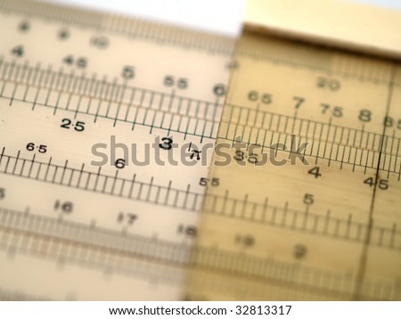 Shallow depth of field close up of slide rule showing cursor and pi