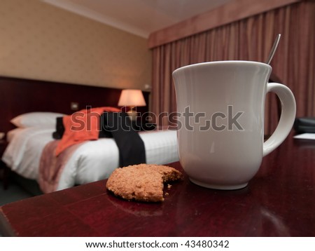 Coffee mug and biscuit in hotel room - business travel