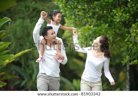 Happy Asian Family enjoying family time together in the park