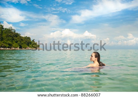 Attractive Asian Woman in the Ocean swimming in the ocean