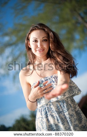 Attractive Asian Female reaching out with open hands