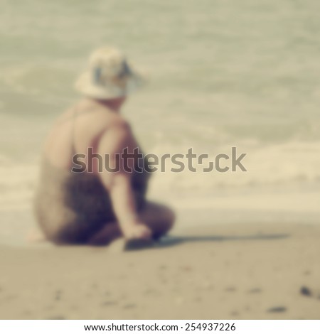 Fat lonely woman sitting on the beach.Special toned photo in vintage style