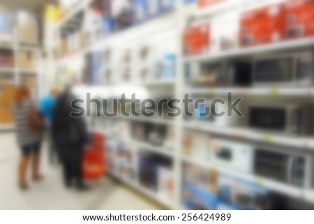 Buyers select the appliances in the store.Specially blurred photo