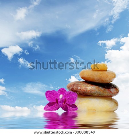 Zen spa concept background-Zen massage stones reflected in water