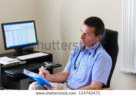 Doctor Writing On A Document In He\'s Practice