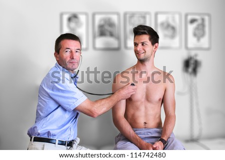 Doctor Doing A Examination of the lungs with a stethoscope In A Private Practice on a young man that is topless