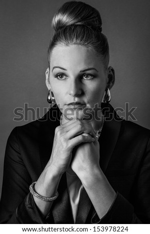 Young woman with folded arms looking serious