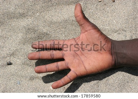 A black hand in the sand