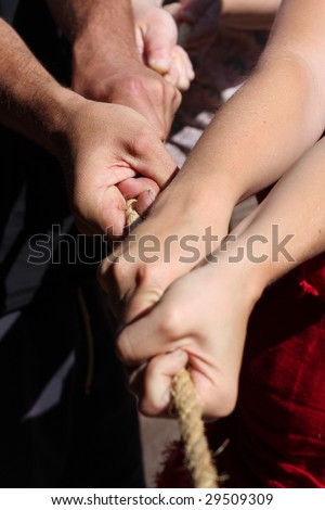 Various people are pulling together at a rope