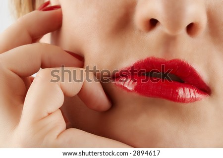 Close-up of red lips and hand. Part of thinking female face.