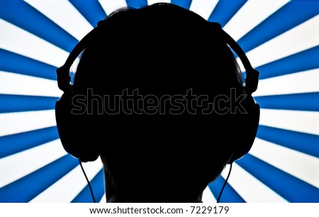 Silhouette of head and earphones against striped background. Focus on earphones.