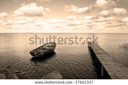 View of boat, bridge and calm sea. Ideal for background. Sepia tone.