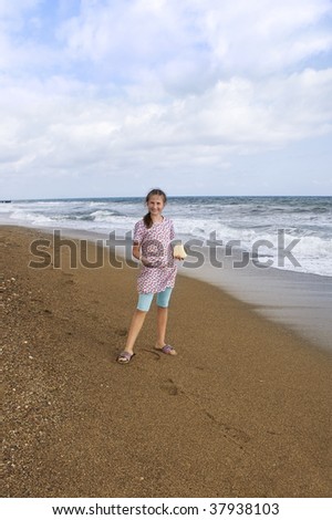 Girl 12 years with stones at sea