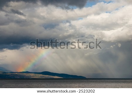 A rainbow breaks through the storm clouds