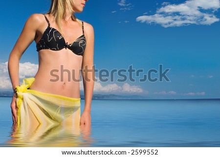 The girl with a yellow scarf on a sea background
