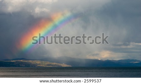 A rainbow breaks through the storm clouds